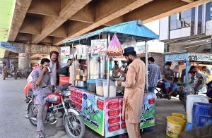 A vendor selling traditional summer drink “sattu” on his cart.