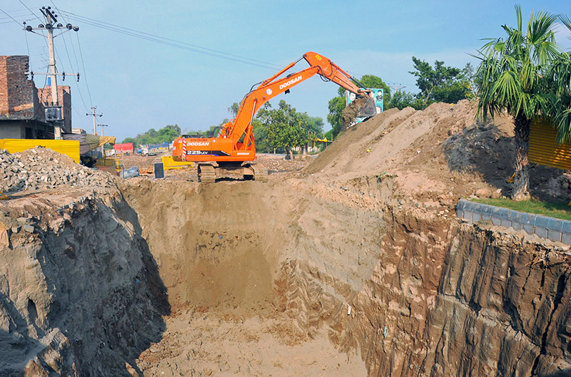An excavator undertakes excavation work for the installation of a new sewerage and drainage system near Vehari Chowk as part of the city's ongoing infrastructure development project