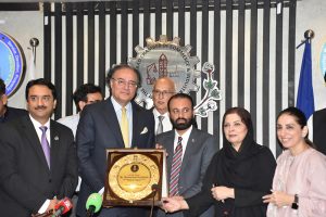 Federal Minister for Finance and Revenue, Mr. Muhammad Aurangzeb, receiving the honorary shield from the president of FCCI after the post Federal budget seminar at Faisalabad Chamber of commerce and industry (FCCI).