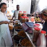 A vendor sells various types of handmade desi pickles inside Delhi Gate