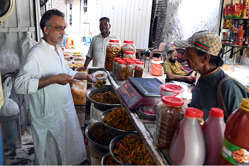 A vendor sells various types of handmade desi pickles inside Delhi Gate