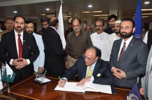 Federal Minister for Finance and Revenue, Mr. Muhammad Aurangzeb, receiving the honorary shield from the president of FCCI after the post Federal budget seminar at Faisalabad Chamber of commerce and industry (FCCI).