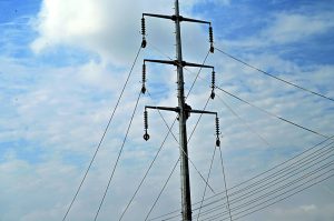 IESCO workers are busy installing new electricity wires on an electric pole at park Road in the Federal Capital