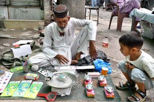 An elderly man buys shoes from a roadside vendor during routine business activity in the city