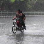 A motorcyclist makes his way through heavy rain in the Provincial Capital