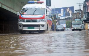 WASA officials work to drain rainwater accumulated at Khayam Chowk following heavy rainfall in the city.