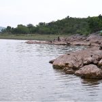 A view of people fishing at Rawal Lake as anglers spend their leisure time along the lakeside