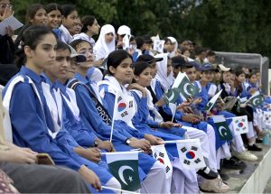 Spectators enjoy the first match of Pakistan-South Korea men's field hockey test series at the Naseer Bunda Hockey Stadium.