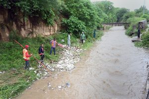 CDA workers clean a drainage nullah along Srinagar Highway as a precautionary measure to ensure the smooth flow of rainwater, prevent urban flooding, and minimize the risk of emergencies during the ongoing monsoon season in the federal capital.