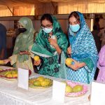 Visitors, including women and children, take interest in different varieties of mangoes displayed during the Mango and Dates Festival 2026 at Muhammad Nawaz Sharif University of Agriculture (MNSUA)