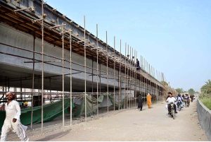 Labourers are busy with their work on the under-construction Shaheed Benazir Flyover at Hala Naka area as part of development work.