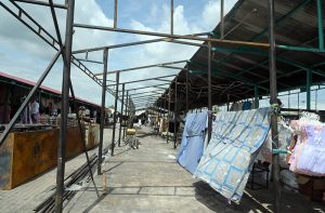 Workers install shade structures over newly rebuilt stalls as reconstruction work continues at the H-9 Weekly Bazaar following the devastating fire that destroyed the market.