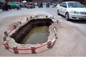 A view of an open manhole in front of Frontier College creates hazard of any mishap needs the attention of concerned authorities.