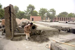 Daily wage labourers prepare reinforced cement concrete (RCC) pipes for drainage and infrastructure projects at a local manufacturing unit in the city
