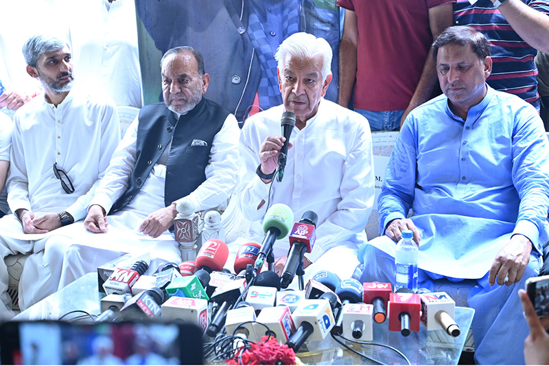 Defence Minister Khawaja Muhammad Asif talks to media persons at Shahabpura