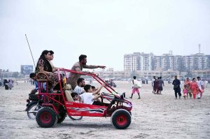 A family enjoys a four-wheeler ride along Seaview, taking advantage of the pleasant weather and spending quality time together.