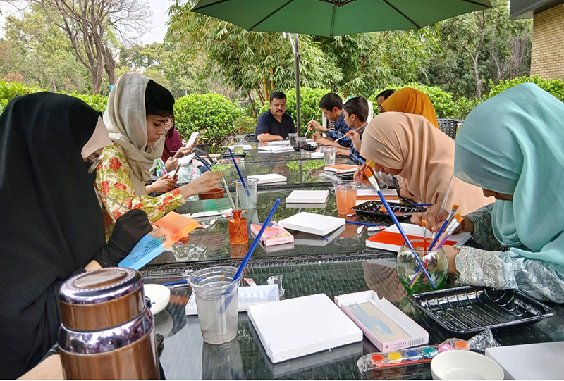 Participants engage in a painting workshop organized by Art Fusion by Mishal in collaboration with Chaaye Khana, Park Road