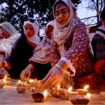 Members of civil society lit earthen lamps outside the Karachi Press Club to protest the killing of labourers in Balochistan