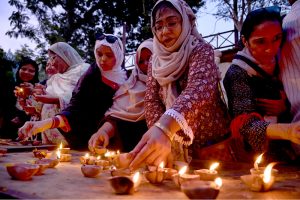 Members of civil society lit earthen lamps outside the Karachi Press Club to protest the killing of labourers in Balochistan