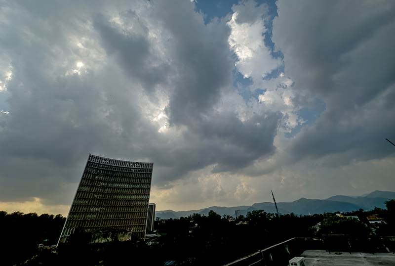 Dense monsoon clouds hover over the Agriculture Building at Zero Point, signaling a likelihood of rain in the federal capital