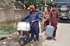 Residents of Sabzal Road in the provincial capital are transporting gallons filled with drinking water to their homes on handcarts.