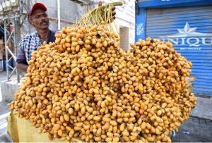 A vendor displays fresh Dates to attract the customers at Bakrani Road.
