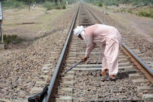 A worker of Pakistan Railways repairs railway track