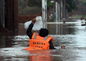 Volunteers distribute cooked meals to flood-affected families in Rana Town following heavy monsoon rains that raised the water level of the Ravi River.
