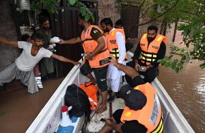 Volunteers distribute cooked meals to flood-affected families in Rana Town following heavy monsoon rains that raised the water level of the Ravi River.