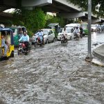 Vehicles passing through stagnant rain water accumulated at Suray Pull Chowk