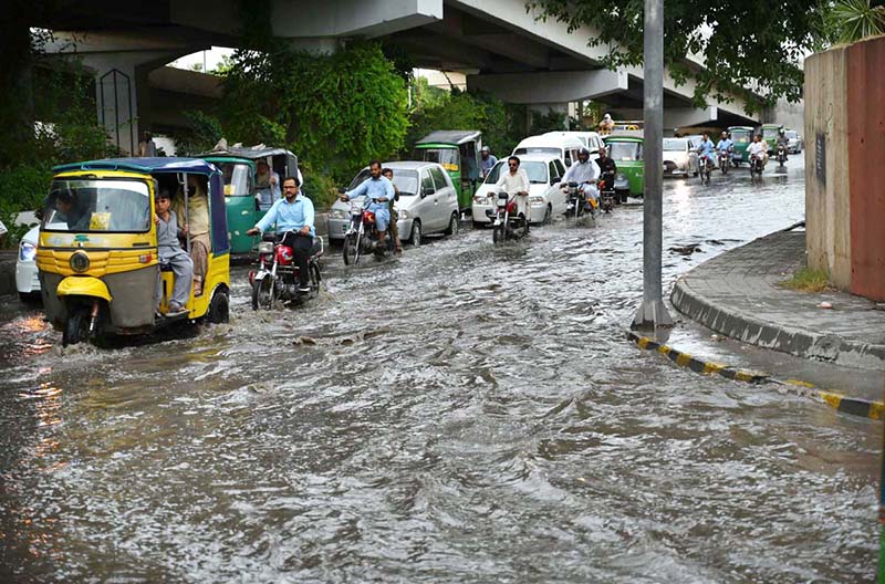 Vehicles passing through stagnant rain water accumulated at Suray Pull Chowk