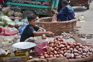 A vendor slices mangoes to prepare pickle at Sabzi Mandi