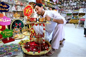 A man preparing wedding event related decoration items at his workplace at Fawara Chowk.