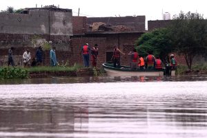 Volunteers distribute cooked meals to flood-affected families in Rana Town following heavy monsoon rains that raised the water level of the Ravi River.