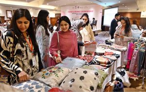 Participants visit the stalls on displayed at the ‘Concluding Ceremony-Empowering Women and Girls (EWG) project’ at a local hotel