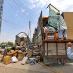 An Afghan national loading household belongings from his residence on a vehicle before departing for Afghanistan under the ongoing repatriation process