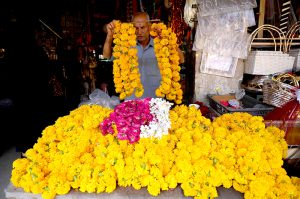 A man preparing wedding event related decoration items at his workplace at Fawara Chowk.