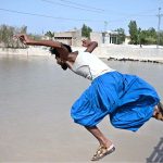 A youngster jumping and bathing in Rice Canal to get some relief from scorching hot weather in the City