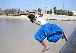 A youngster jumping and bathing in Rice Canal to get some relief from scorching hot weather in the City