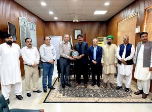 Professor Dr. Muhammad Kamran, Vice Chancellor of the Islamia University of Bahawalpur presenting IUB’s centenary celebrations souvenir to Chairman BISE Bahawalpur.