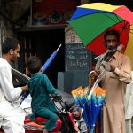 A street vendor displaying and selling the umbrella to the customers at old city in the Provincial Capital