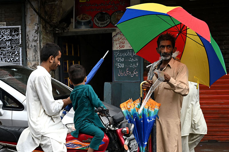 A street vendor displaying and selling the umbrella to the customers at old city in the Provincial Capital