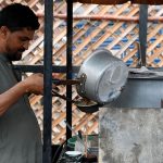 A vendor is busy in making and selling the tea to the customers on the roadside setup in the Provincial Capital
