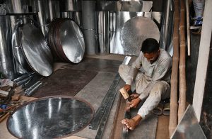 Workers busy in preparing iron containers and boxes to the customers at their workplace.