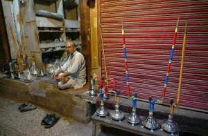 A vendor waiting for the customers as displays different parts of the traditional smoking pot Hookah at his shop in the provincial capital.