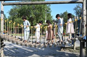 Children enjoy a zip-line ride during their summer vacation at the Japanese Park in the Federal Capital.