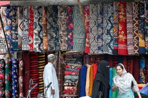 Ladies selecting and purchasing the colorfull bedsheets, curtains and other fabrics from a vendor near Dehli gate.