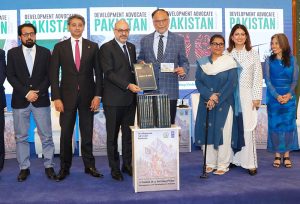 Federal Minister for Planning, Development & Special Initiatives, Professor Ahsan Iqbal, holding the latest issue of Development Advocate Pakistan during its launch at the Strategic Dialogue on “A Nation at a Turning Point: Demographics and Development in Pakistan”