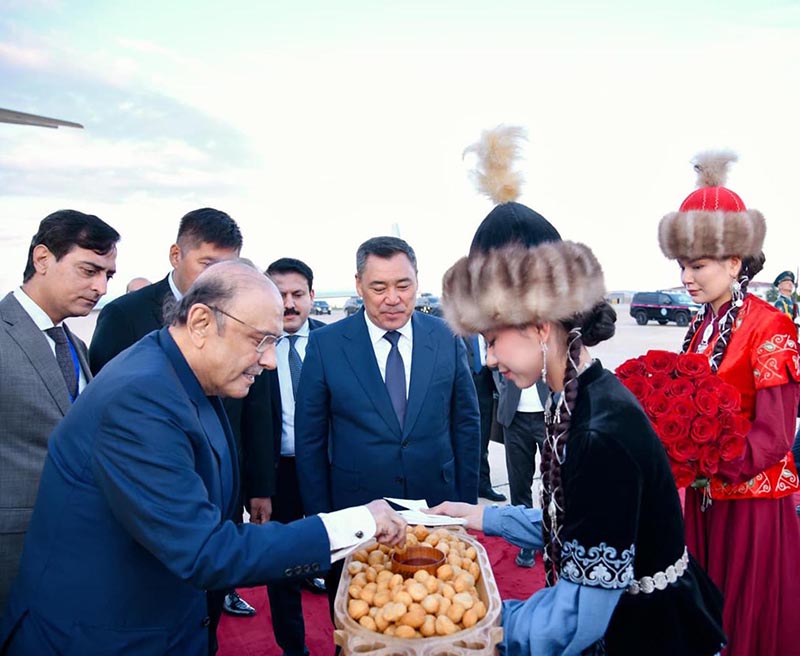 President of Pakistan Asif Ali Zardari is presented with traditional Kyrgyz boorsok and honey as part of the official welcome ceremony upon his arrival at Issyk-Kul International Airport, in the presence of President of the Kyrgyz Republic Sadyr Japarov