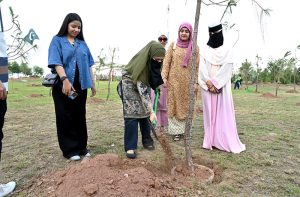 Students plant a sapling during the Tree Plantation Drive organized by the Clean & Green Islamabad Movement at Parade Ground in the federal capital